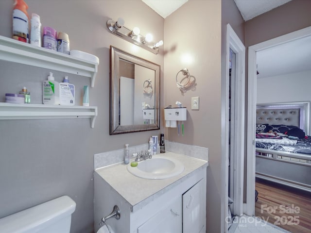 6820 Elm Forest Dr, Charlotte, NC 28212 - half bathroom with vanity, toilet, and wood finished floors