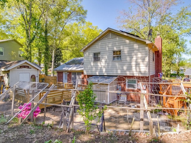 6820 Elm Forest Dr, Charlotte, NC 28212 - rear view of house with a chimney, brick siding, fence, and an outbuilding