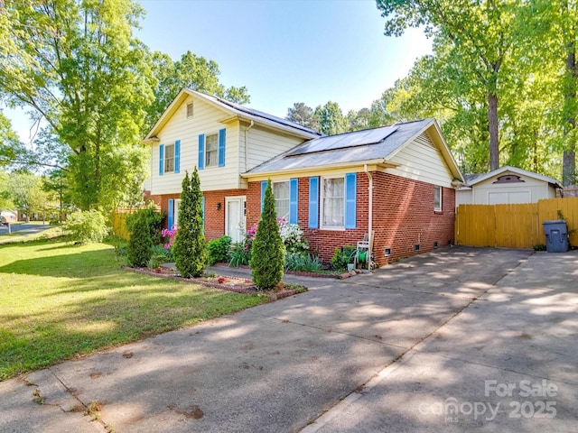 6820 Elm Forest Dr, Charlotte, NC 28212 - tri-level home with roof mounted solar panels, fence, concrete driveway, brick siding, and a front lawn