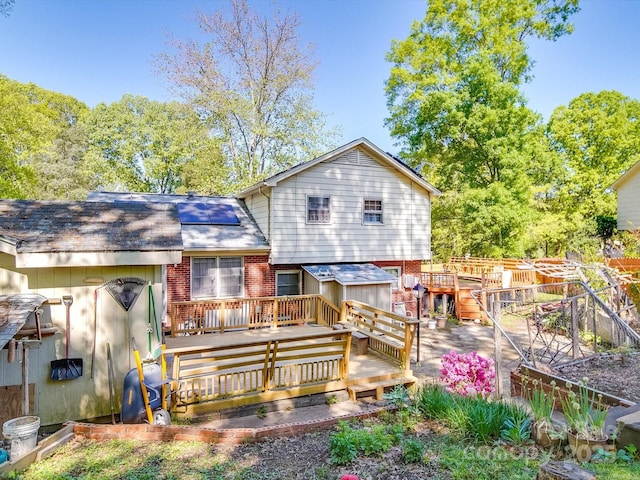 6820 Elm Forest Dr, Charlotte, NC 28212 - back of house featuring roof with shingles, brick siding, a wooden deck, and fence