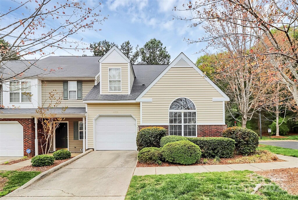 11539 Delores Ferguson Ln, Charlotte, NC 28277 - traditional-style home featuring brick siding, a garage, and concrete driveway