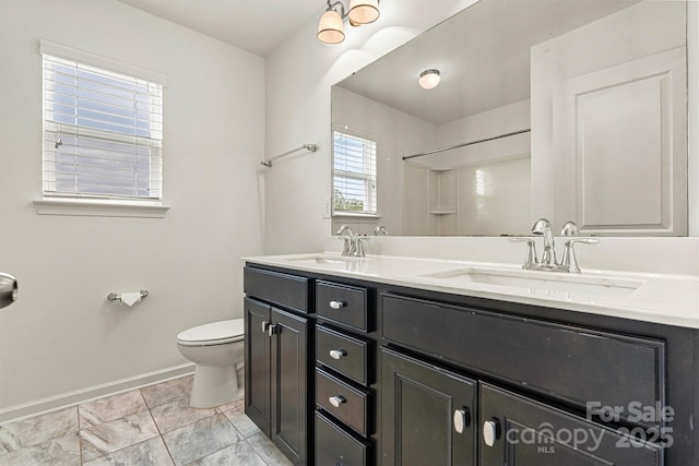 1617 Post Ct, Gastonia, NC 28054 - full bathroom with baseboards, toilet, double vanity, and a sink