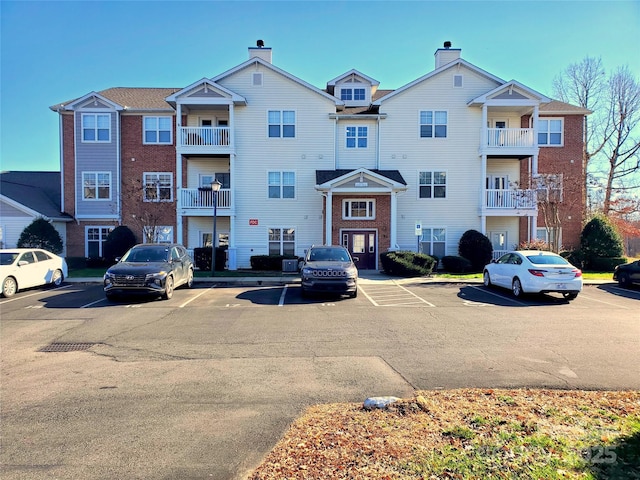 view of property featuring uncovered parking