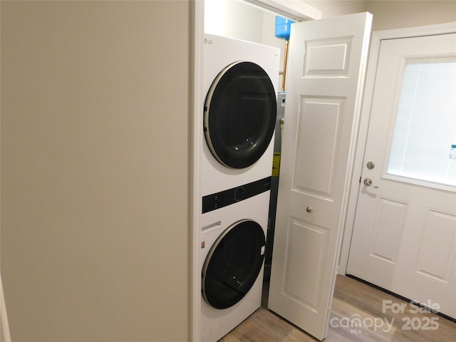 109 W Poplar St, Stanley, NC 28164 - clothes washing area featuring stacked washer and dryer, laundry area, and light wood finished floors