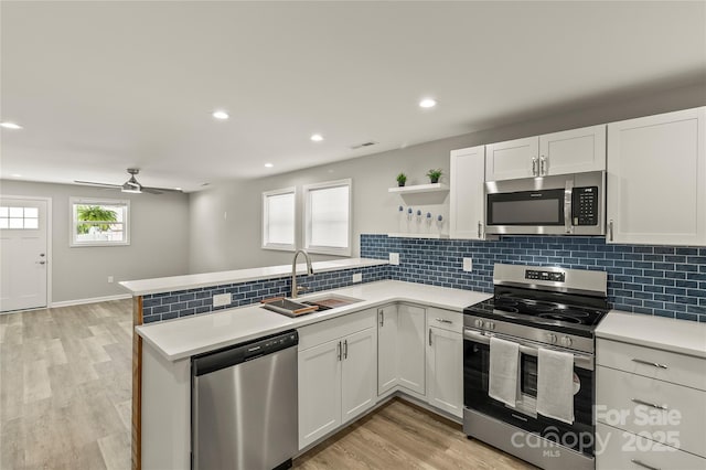 109 W Poplar St, Stanley, NC 28164 - kitchen featuring stainless steel appliances, open shelves, a peninsula, white cabinetry, and recessed lighting