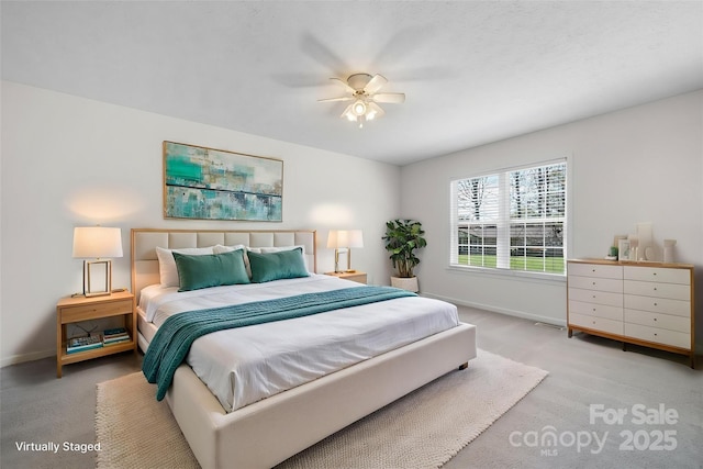 bedroom featuring baseboards, light colored carpet, ceiling fan, and visible vents