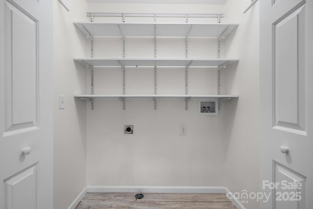 laundry room with baseboards, laundry area, washer hookup, and light wood-style flooring