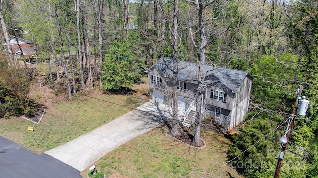 birds eye view of property featuring a view of trees
