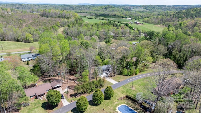drone / aerial view with a wooded view