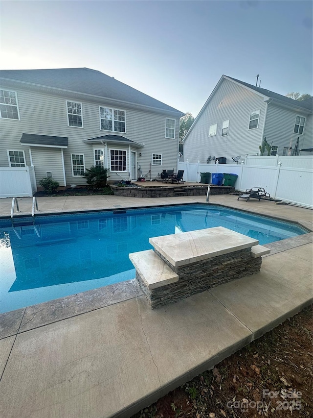 view of pool with a fenced in pool, a patio area, and fence