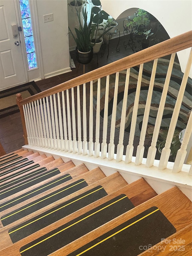 staircase with wood finished floors