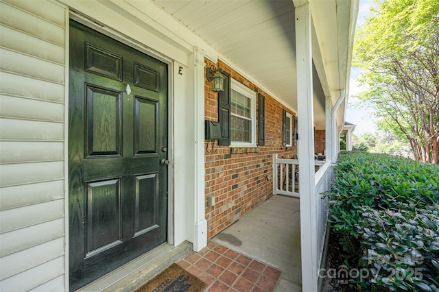 view of exterior entry with covered porch
