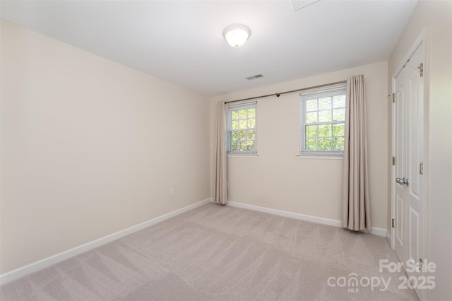 unfurnished bedroom with light carpet, baseboards, and visible vents