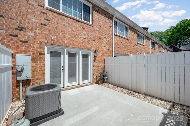 view of patio featuring central AC and fence