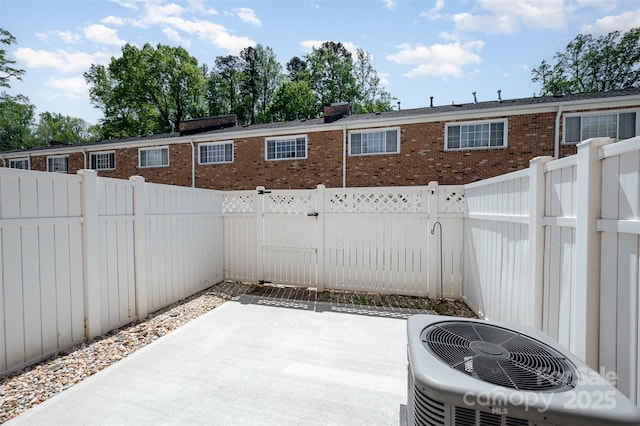 view of patio / terrace with central air condition unit and a fenced backyard