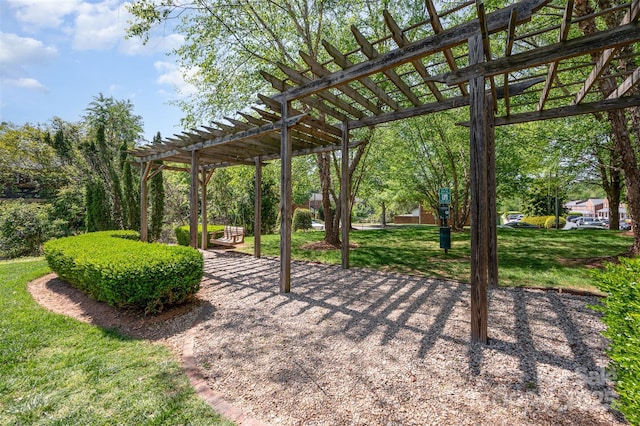 exterior space with a pergola and a lawn