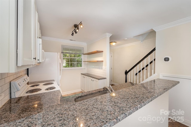 kitchen featuring open shelves, white appliances, a sink, and crown molding