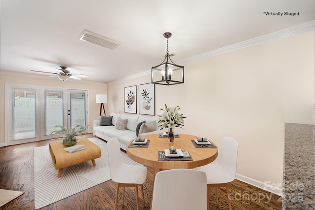 dining area with ceiling fan, wood finished floors, visible vents, and ornamental molding