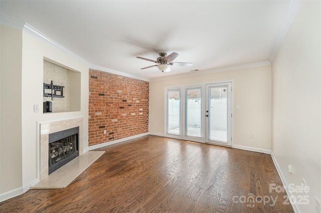 unfurnished living room featuring crown molding, ceiling fan, wood finished floors, and baseboards