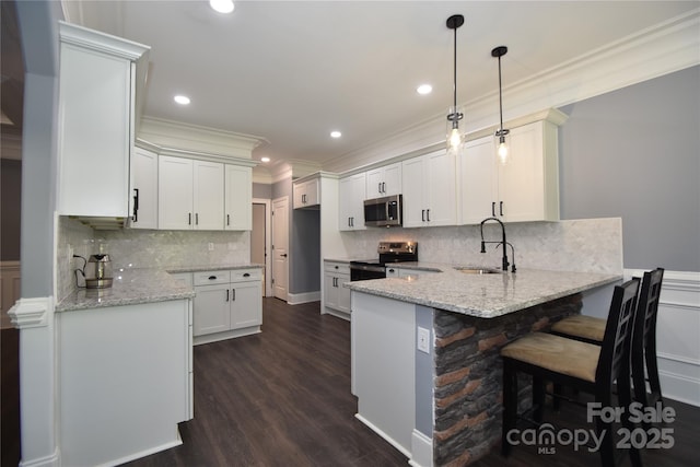 6519 Pargo Rd, Charlotte, NC 28216 - kitchen with crown molding, a peninsula, light stone countertops, a sink, and stainless steel appliances