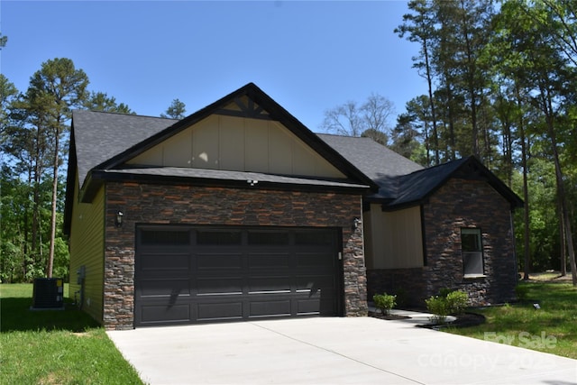 6519 Pargo Rd, Charlotte, NC 28216 - view of front of property featuring a shingled roof, an attached garage, concrete driveway, and stone siding