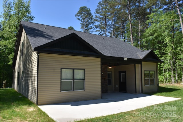 6519 Pargo Rd, Charlotte, NC 28216 - view of front of home featuring a patio, a shingled roof, and a front lawn