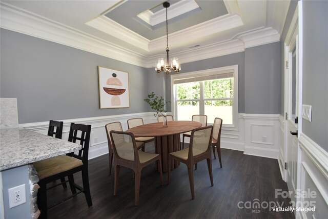 6519 Pargo Rd, Charlotte, NC 28216 - dining space featuring dark wood-style flooring, an inviting chandelier, wainscoting, a tray ceiling, and ornamental molding