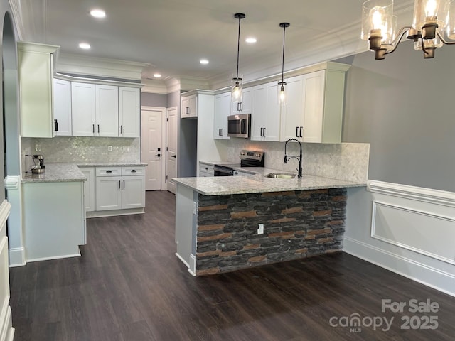 6519 Pargo Rd, Charlotte, NC 28216 - kitchen with light stone countertops, a sink, stainless steel appliances, a peninsula, and ornamental molding