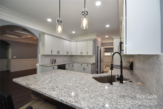 6519 Pargo Rd, Charlotte, NC 28216 - kitchen with ornamental molding, light stone countertops, a peninsula, and white cabinetry