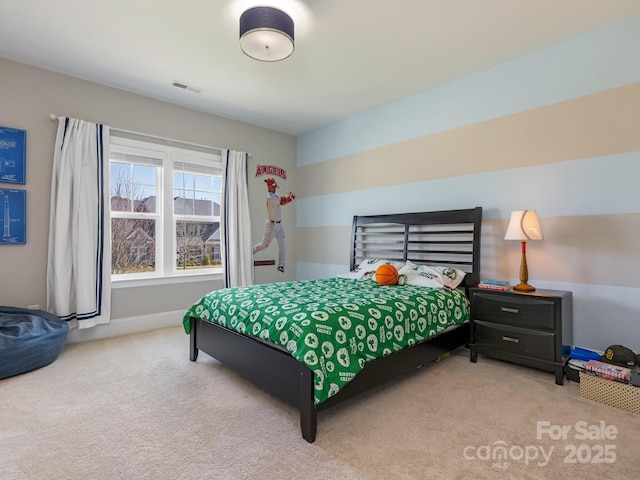carpeted bedroom featuring baseboards and visible vents