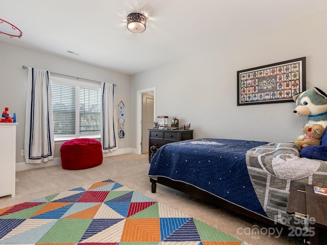 carpeted bedroom featuring visible vents and baseboards