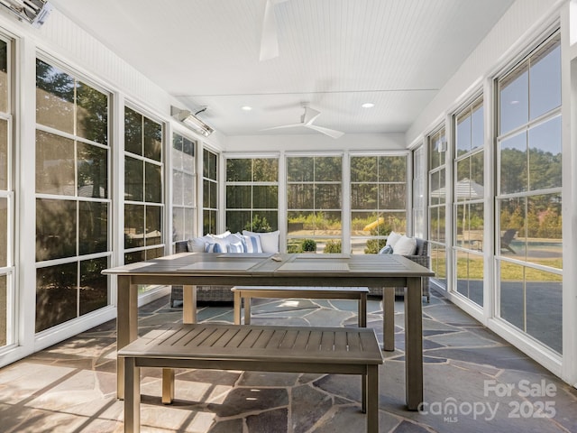 sunroom / solarium featuring an outdoor hangout area, ceiling fan, and a wealth of natural light