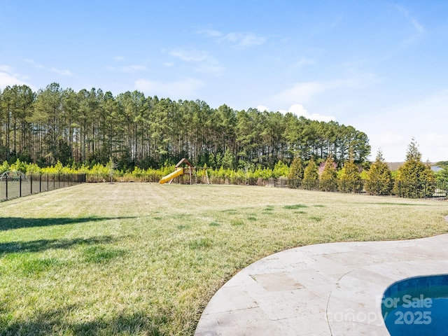 view of yard with playground community and fence