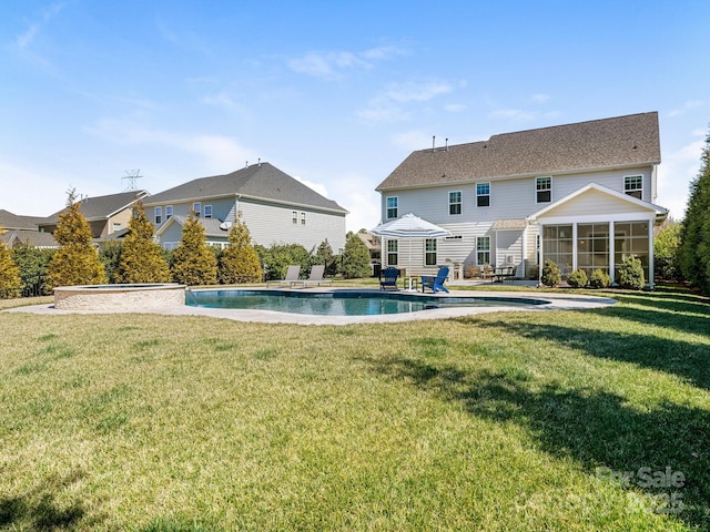 outdoor pool featuring a patio, a sunroom, and a lawn