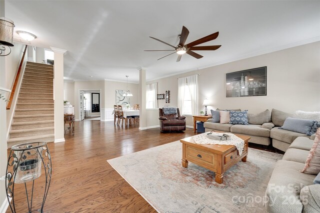 985 Angelica Ln, Tega Cay, SC 29708 - living area featuring wood finished floors, stairway, baseboards, ceiling fan with notable chandelier, and ornamental molding