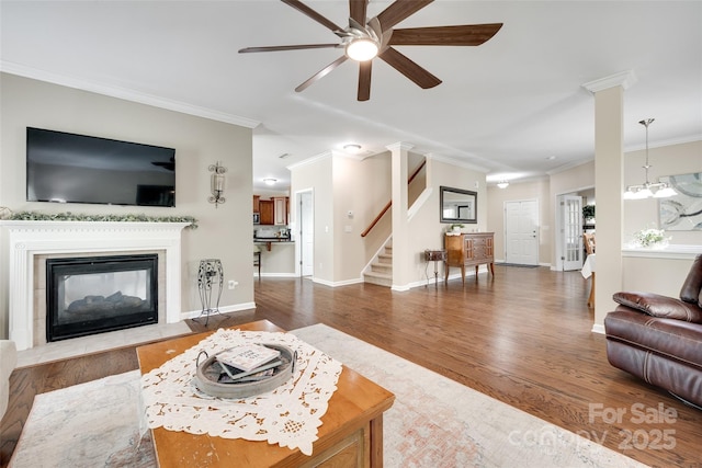 985 Angelica Ln, Tega Cay, SC 29708 - living room with crown molding, a ceiling fan, wood finished floors, and stairway