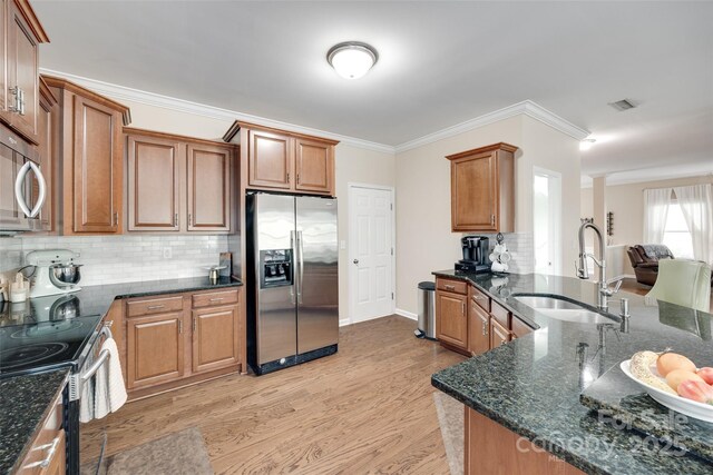 985 Angelica Ln, Tega Cay, SC 29708 - kitchen with crown molding, backsplash, appliances with stainless steel finishes, and a sink