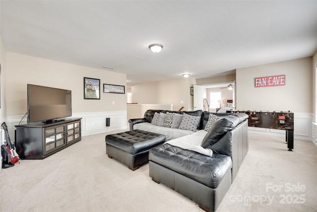 985 Angelica Ln, Tega Cay, SC 29708 - living area featuring ceiling fan, light colored carpet, wainscoting, and a decorative wall
