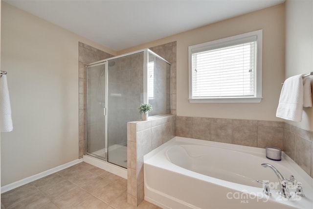 985 Angelica Ln, Tega Cay, SC 29708 - full bath featuring a garden tub, baseboards, tile patterned floors, and a shower stall
