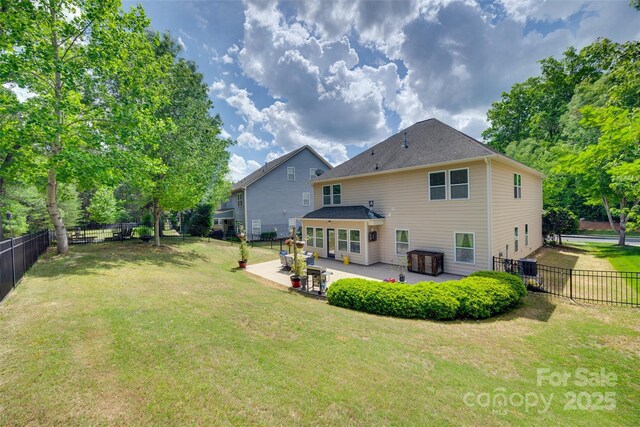 985 Angelica Ln, Tega Cay, SC 29708 - back of property with a patio, a fenced backyard, and a yard