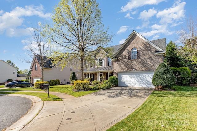 6941 Augustine Way, Charlotte, NC 28270 - traditional home with a garage, driveway, a front yard, and brick siding