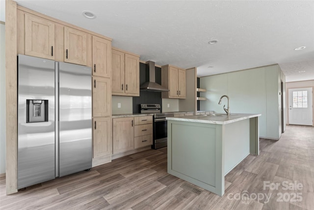 5989 Kaylas Ridge Rd, Connelly Springs, NC 28612 - kitchen with appliances with stainless steel finishes, wall chimney exhaust hood, light brown cabinets, light wood-style floors, and recessed lighting