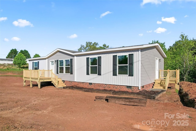 5989 Kaylas Ridge Rd, Connelly Springs, NC 28612 - manufactured / mobile home with crawl space and a wooden deck