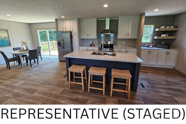 5989 Kaylas Ridge Rd, Connelly Springs, NC 28612 - kitchen featuring stainless steel appliances, wall chimney range hood, a textured ceiling, light countertops, and backsplash