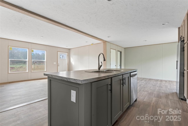 5989 Kaylas Ridge Rd, Connelly Springs, NC 28612 - kitchen featuring gray cabinets, a textured ceiling, wood finished floors, dark countertops, and a center island with sink