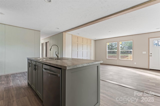 5989 Kaylas Ridge Rd, Connelly Springs, NC 28612 - kitchen with stainless steel dishwasher, a textured ceiling, wood finished floors, gray cabinets, and a kitchen island with sink