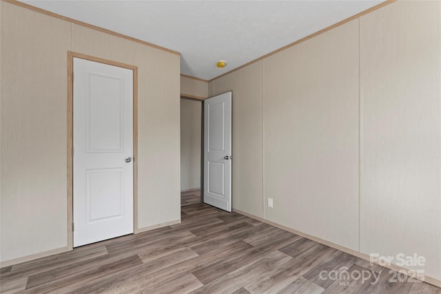 5989 Kaylas Ridge Rd, Connelly Springs, NC 28612 - unfurnished bedroom with wood finished floors and crown molding