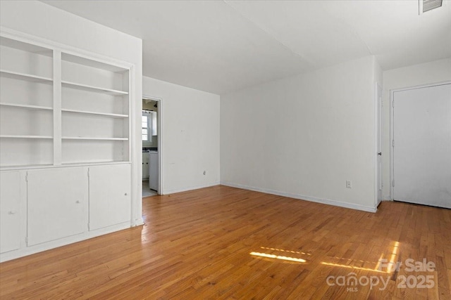 343 Wakefield Dr Unit C, Charlotte, NC 28209 - unfurnished living room featuring wood finished floors and baseboards