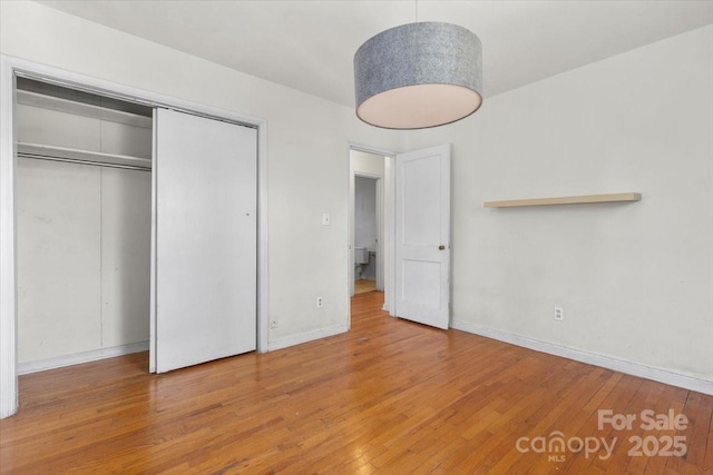 343 Wakefield Dr Unit C, Charlotte, NC 28209 - unfurnished bedroom with wood finished floors, baseboards, and a closet
