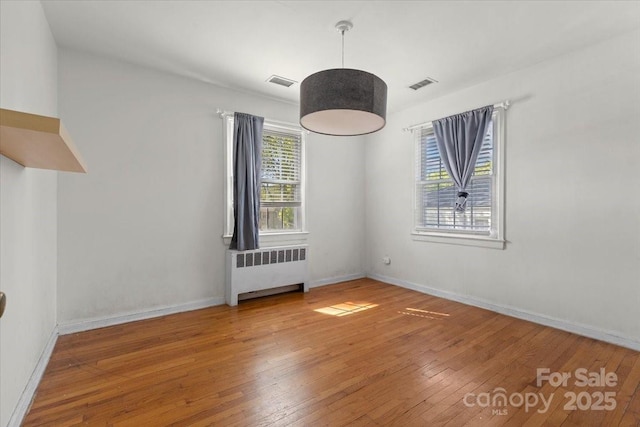 343 Wakefield Dr Unit C, Charlotte, NC 28209 - unfurnished room with radiator heating unit, hardwood / wood-style floors, and baseboards